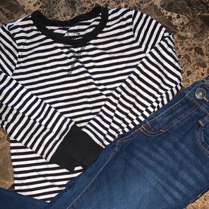 Long sleeve shirt paired with jeans.